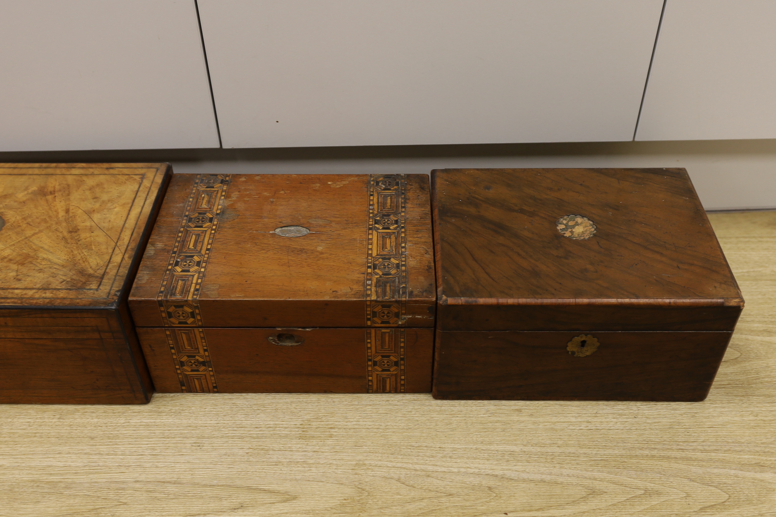Three Victorian writing boxes and a tea caddy, largest 35cm wide, 15cm high, 24cm deep